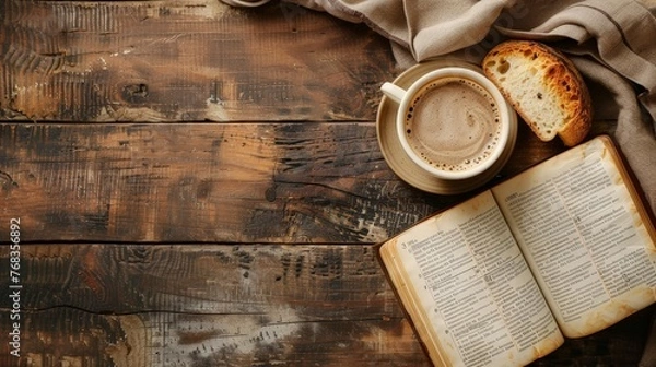 Fototapeta Wooden table with open bible, cup of coffee and bread