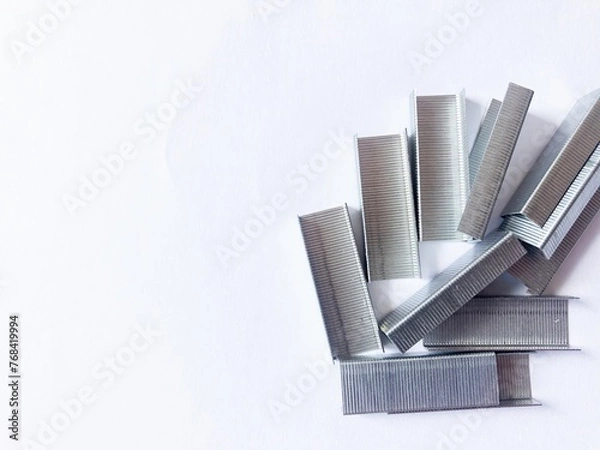 Fototapeta Stapler, hand and box of staples on white background.