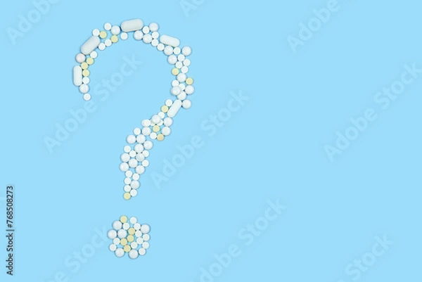 Obraz medical preparations laid out in the form of a question mark on a blue background