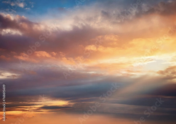 Fototapeta Sky with clouds at sunset, painted in hues of orange and red, under the warm glow of the sun, creating a beautiful evening scene