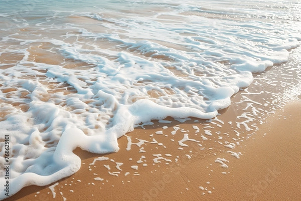 Fototapeta Waves rolling onto the beach, a peaceful and invigorating seaside view