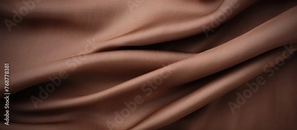 Fototapeta Close up of a textured brown fabric with a very long line running across, creating a unique pattern. Top view of the rich brown fabric background.