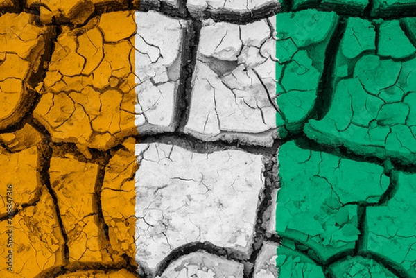 Fototapeta Dry soil pattern on the flag of Cote d'Ivoire. Country with drought concept due to climate change. Water problem. Dry cracked earth country.