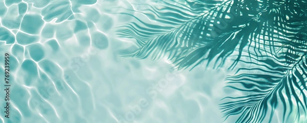 Fototapeta Summer vacation and travel concept. Shadow of a palm tree on water. Empty space for advertisement 