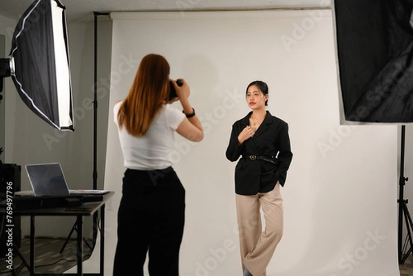 Fototapeta Beautiful young mode for professional photographer in photo studio