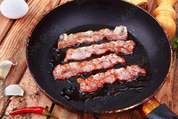 Obraz Fried bacon in a frying pan