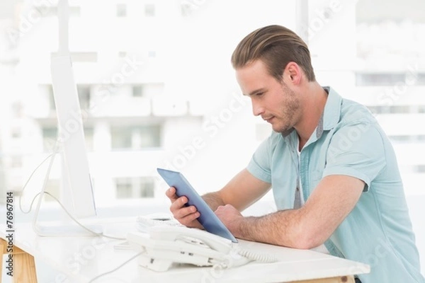 Fototapeta Casual businessman using tablet