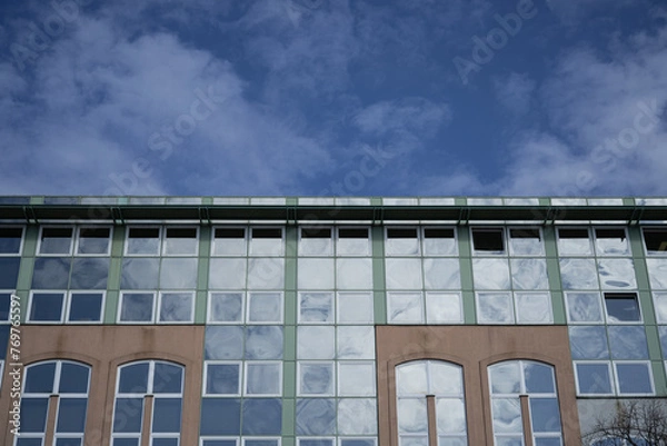 Fototapeta color windows on a building blue sky