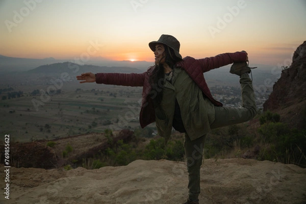 Fototapeta Young mexican girl enjoying the sunriese in the top of a mountain