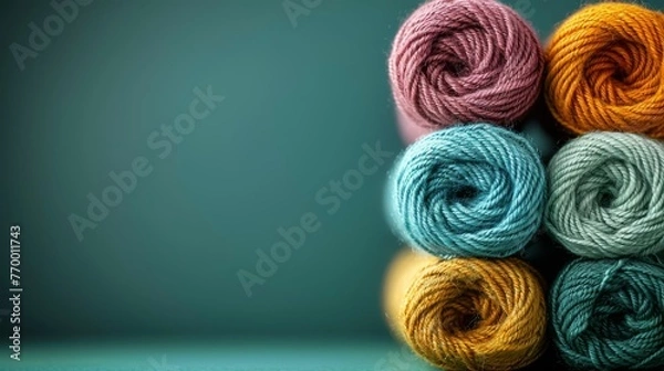 Fototapeta   Several skeins of yarn stacked on top of each other in various shades of the same color