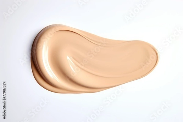 Fototapeta A creamy swatch of makeup is elegantly smeared against a smooth, neutral-toned backdrop.