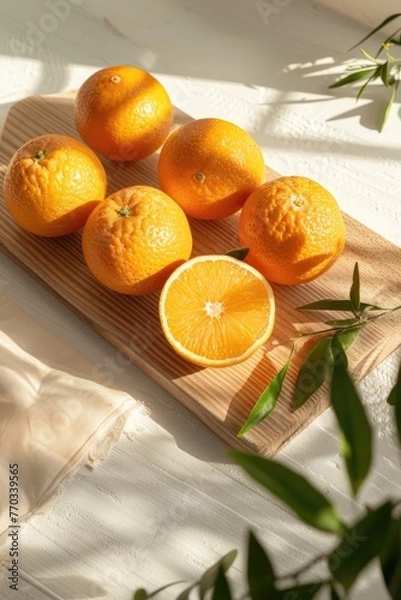 Fototapeta Oranges on bright rustic counter top.