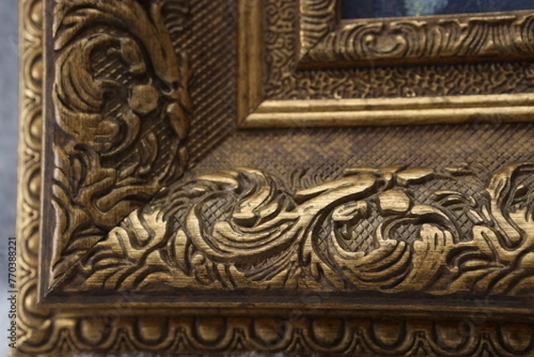 Fototapeta the corner of the frame for the picture is made of an antique baguette of golden color