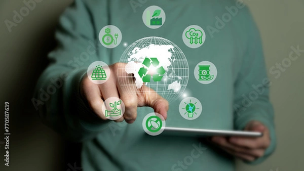 Fototapeta Climate change to limit global warming and sustainable development and green business concept. Businessman with green world and renewable energy icons.
