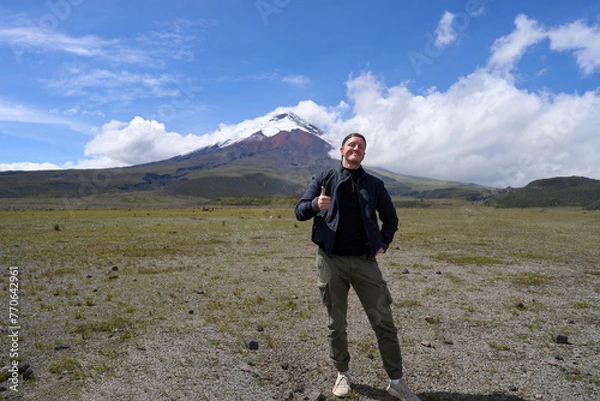 Obraz Solo traveler and the Cotopaxi active volcano in Ecuador, South America, hiking tour to the mountain with a snow peak, beautiful landscape.