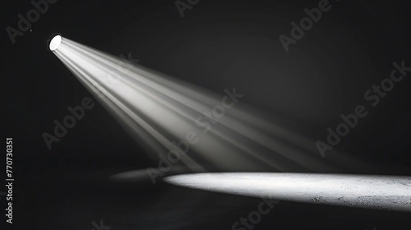 Fototapeta A spotlight shines down on an empty stage. The spotlight is bright and focused, creating a pool of light on the stage.