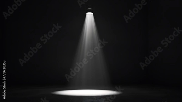 Fototapeta A spotlight shines down on an empty stage. The spotlight is bright and focused, creating a pool of light on the stage.