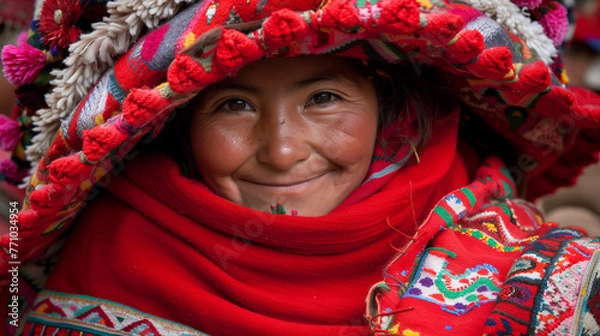 Fototapeta A young peruvian woman with a colorful red hat smiling at the camera. Andes. Wool chullo. American rural native folk.