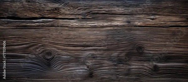 Fototapeta A detailed closeup of a brown hardwood surface with visible knots and grain patterns, resembling soil or bedrock outcrop