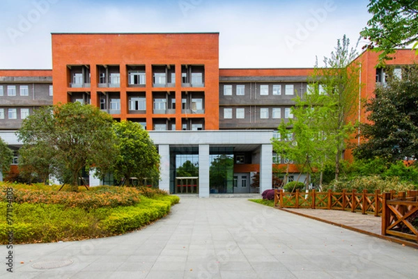 Fototapeta On the university campus, a new teaching building stands high