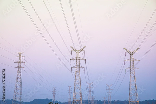 Fototapeta The high-voltage electric tower appears very majestic and spectacular in the sky