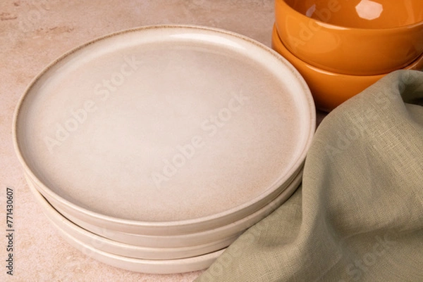 Fototapeta A selection of tableware on a brown stone tabletop.