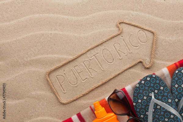 Fototapeta Puerto Rico  pointer and beach accessories lying on the sand