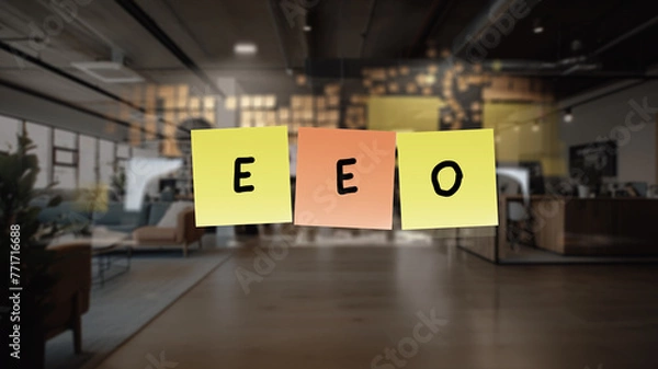 Fototapeta EEO written in black marker. The notes are affixed to a transparent surface in front of open office, three sticky notes, each with a single letter .