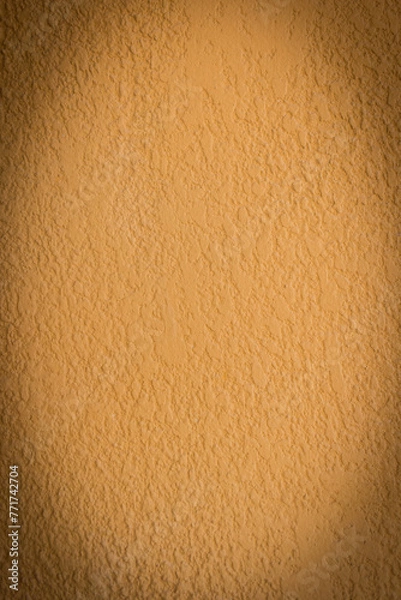 Obraz Black vignette vertical photo on the background of plaster wall mustard color stucco molding blank space text empty