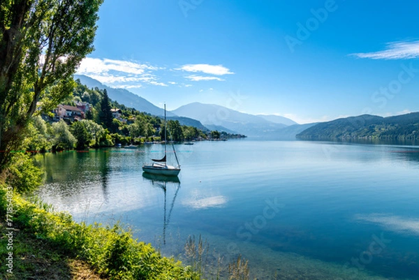 Fototapeta Serene Austrian Lake with Anchored Boat and Natural Frame