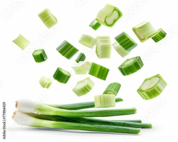 Fototapeta Flying spring onions isolated on white background. Clipping path included.