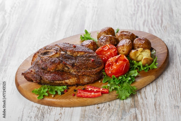 Fototapeta roasted pork shoulder on the bone with potatoes