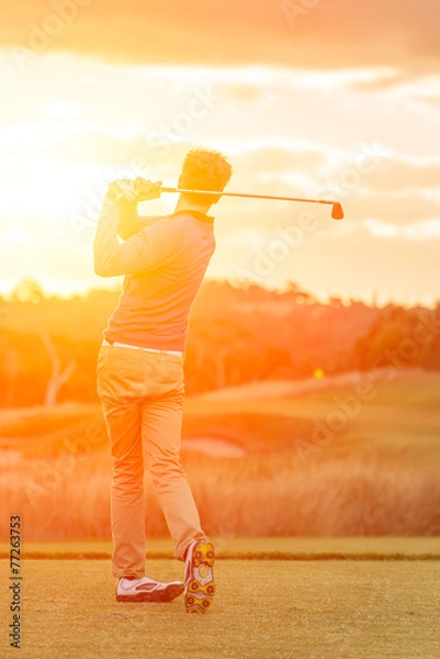 Obraz Golf player tee off at sunset