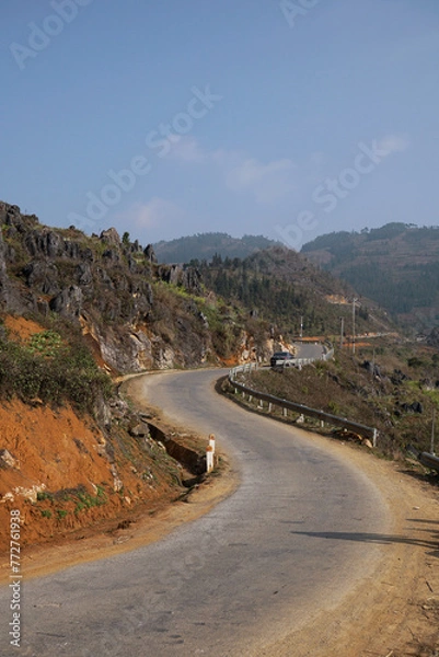 Fototapeta Curving road of Ha Giang loop with one cliff side and one mountain side