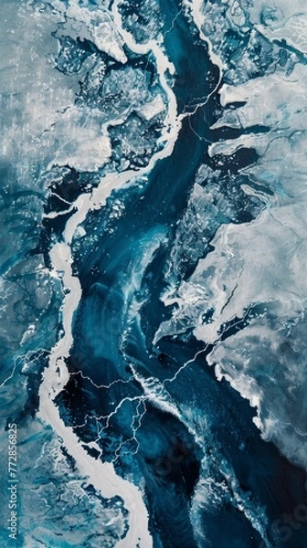 Fototapeta Aerial view of a frozen river breaking up during spring thaw