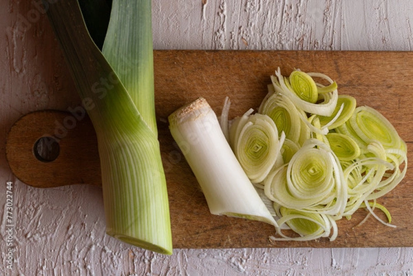 Obraz Sliced leek on a wooden board.
