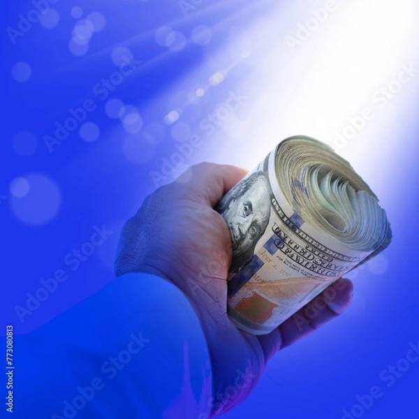 Obraz close up businessman hand holding rolled up American hundred dollars pile over white background