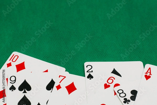 Obraz A pile of Poker playing card, playing cards on green background.;