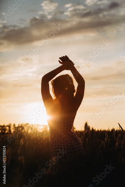 Obraz silhouette of a girl at sunset in the field