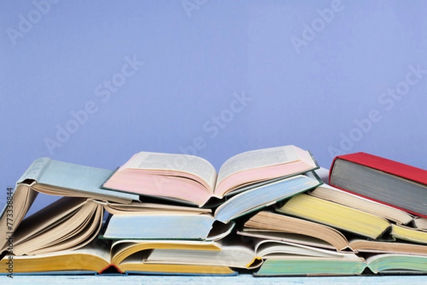 Fototapeta Open book, hardback colorful books on wooden table. Back to school. Copy space for text. Education business concept.