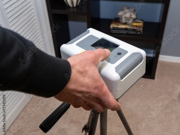 Obraz Home inspector doing a radon test setup in the lowest bedroom of a home.