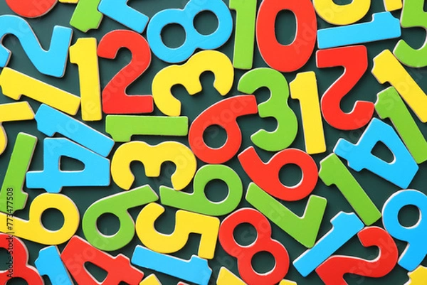Fototapeta Colorful numbers on green background, top view