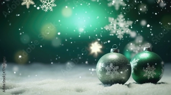 Fototapeta Beautiful Matt Green Christmas Ornaments on Snow Flakes Over an Abstract Background with Room For Your Own Text.