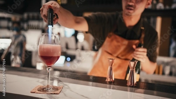 Obraz Bartender making a cocktail at the bar.