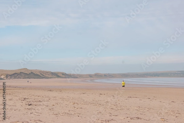 Fototapeta person running on beach