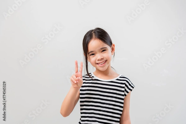 Obraz image of Asian child posing Hold up 2 fingers on white background