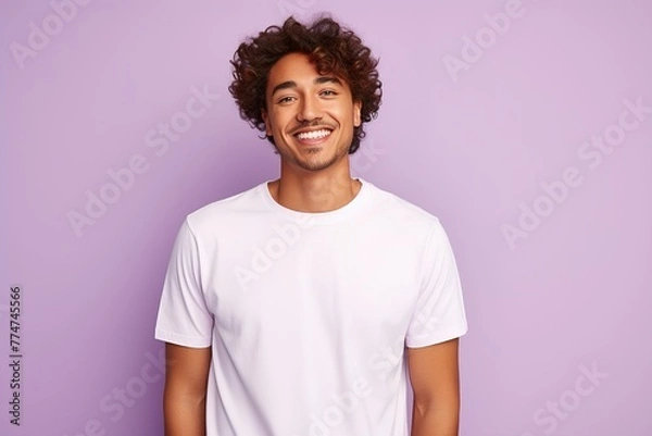 Obraz A man with a white shirt and curly hair is smiling at the camera