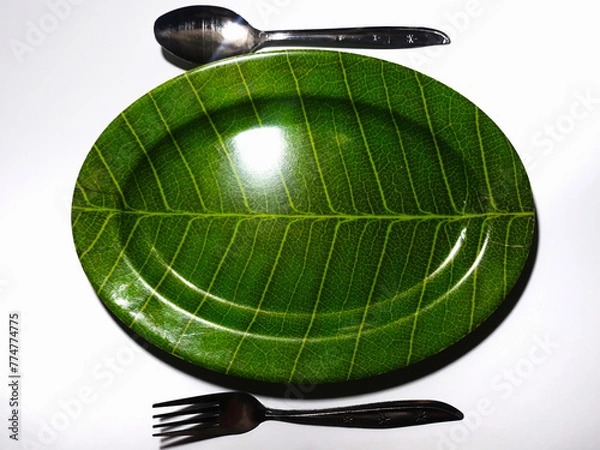 Obraz Empty green plate leaf pattern theme with spoon and fork isolated white background