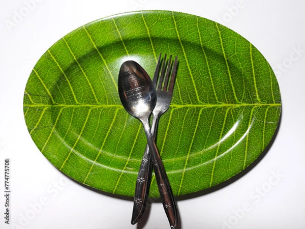 Obraz Empty green plate leaf pattern theme with spoon and fork isolated white background