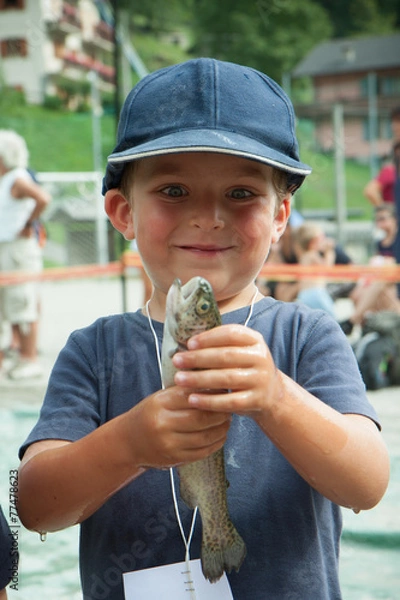 Fototapeta happy child with a trout
